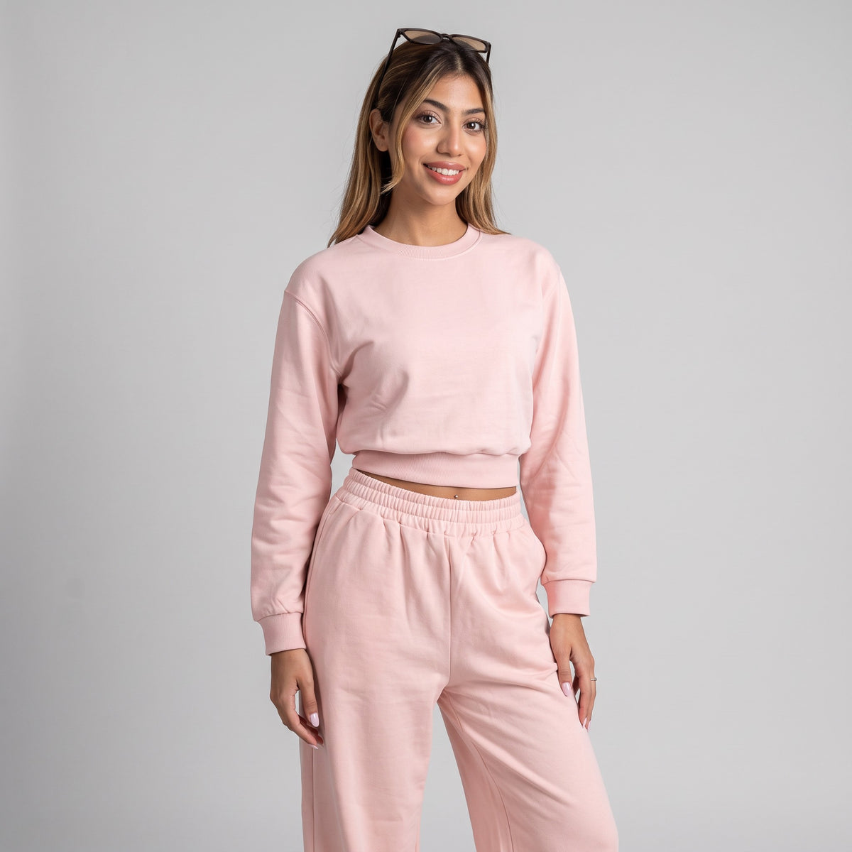 Pink cropped sweatshirt and joggers seen straight on