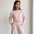 Blush pink set styled with sunglasses resting on the hair