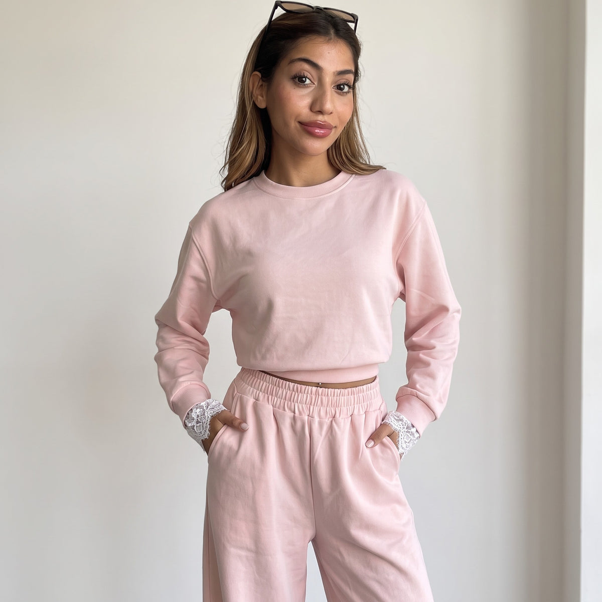 Blush pink set styled with sunglasses resting on the hair