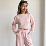 Blush pink set styled with sunglasses resting on the hair
