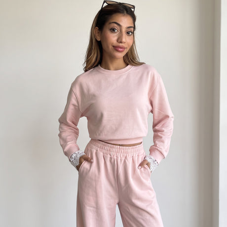 Blush pink set styled with sunglasses resting on the hair