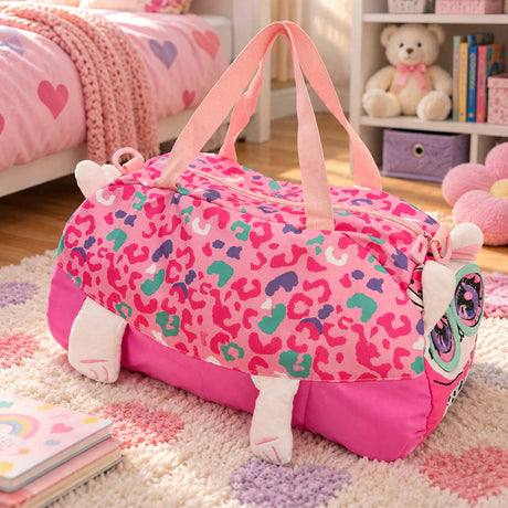 Pink leopard print duffle bag with a kitty face, plush ears and paws on a pastel heart rug