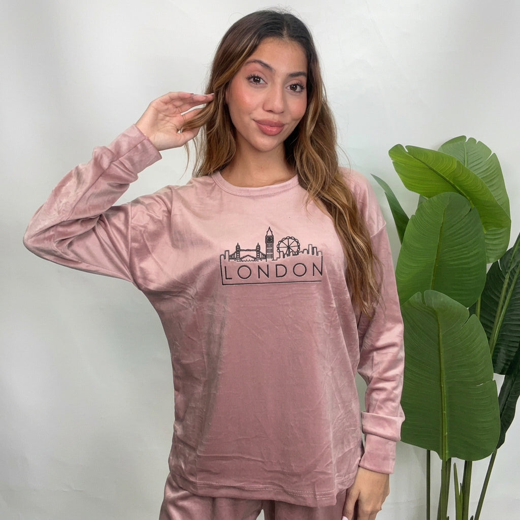 Close up of a dusty pink velvet pajama top with a black London skyline print