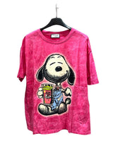 Pink tshirt with cartoon dog character design jolding a cup on a hanger