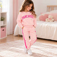Girl in a pink Pancakes sweatshirt and pink joggers with hot pink side stripes