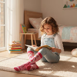 Girl in denim overalls wearing pink Pink Panther socks pulled up to the knee
