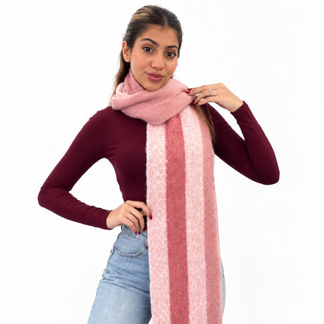 Woman in a burgundy top wearing a long light pink brushed scarf with a deep rose centre stripe
