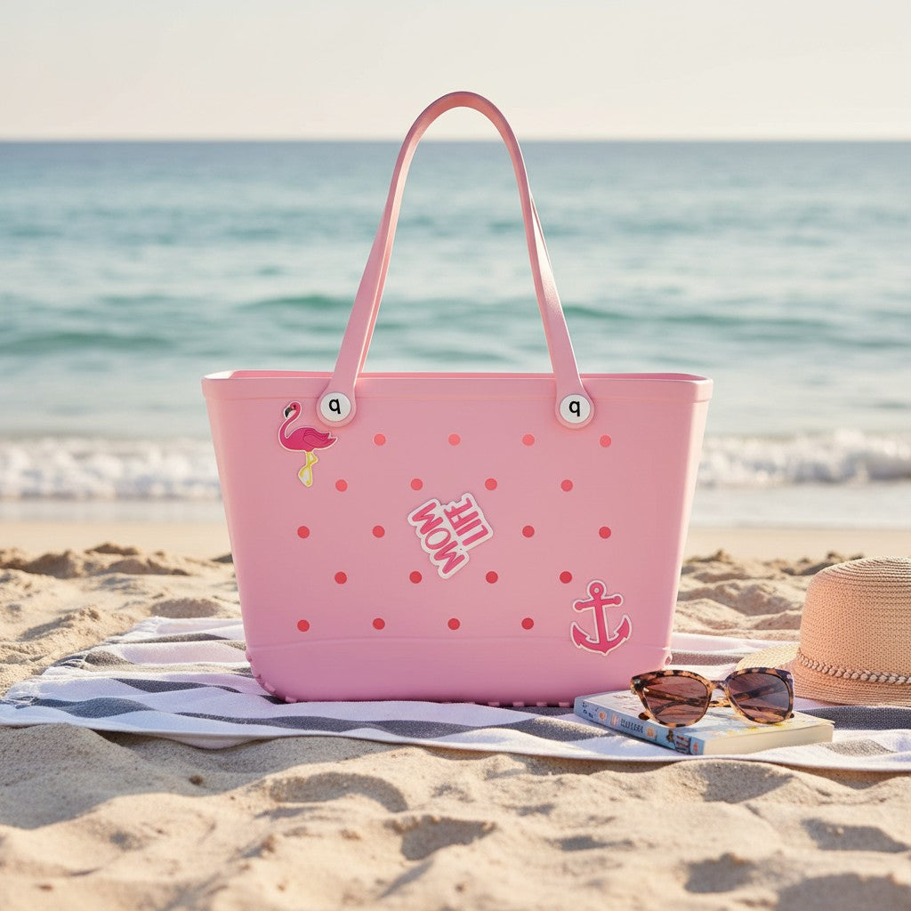 Pink tote bag with flamingo design on a sandy beach