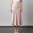 Person wearing a pink skirt on a plain background