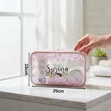 Pink 'Hello Spring' pouch with measurements 15x25cm on a marble surface
