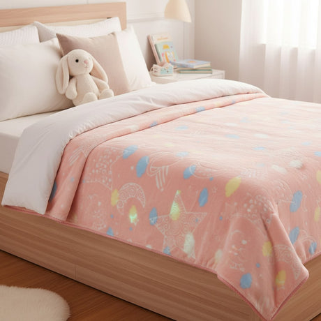Pink fleece blanket with pastel stars spread over a bed
