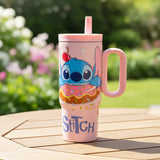 Pink Stitch donut print tumbler on a garden table with flowers behind
