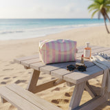 Pink striped waterproof beach pouch with zip closure