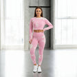 Woman wearing a pink athletic outfit with white floral patterns in a bright room
