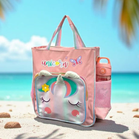Pink kids tote bag with a holographic unicorn face pocket and a water bottle in the mesh side pocket
