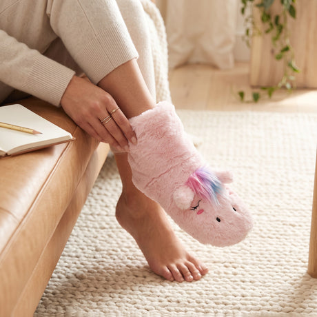 Pink plush unicorn slipper sock with a rainbow mane and cream sherpa cuff