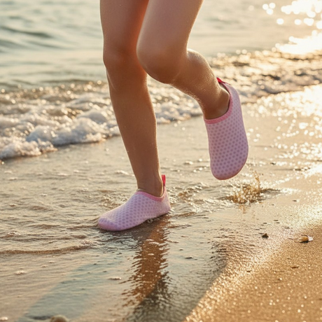 Kids pink polka-dot water shoes worn on the beach at the water's edge – Jack Gifts Online Lebanon