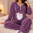 Plum purple fleece pyjama top and pants with white trim and a cat with a pink yarn heart
