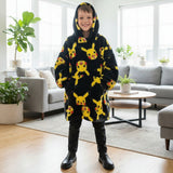 Child in a black hooded blanket with a yellow Pikachu print