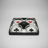 Set of four clear ashtrays with playing card suits in a black box on a light grey background