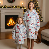 Two girls in matching light blue fleece hooded blankets with a polar bear Christmas print