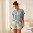 Woman wearing blue polar bear print cotton pyjama set in bedroom - cozy homewear gift - Jack Gifts Lebanon