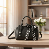 Black pebbled mini handbag with white polka dot scarf bow and silver hardware