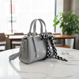 Grey mini handbag with detachable crossbody strap and polka dot scarf bow