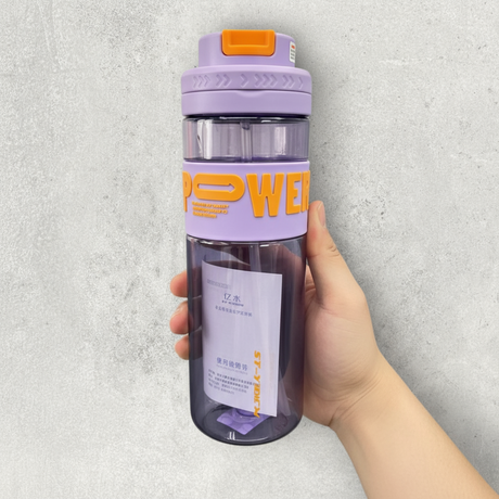 Hand holding a lilac Power water bottle with a flip lid