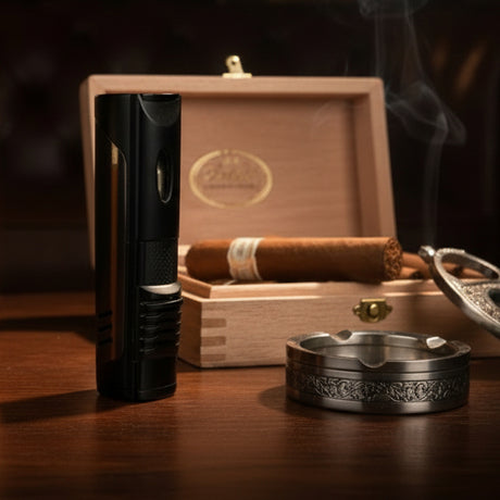 Cigar lighter, wooden humidor with cigars, and ashtray on a wooden surface