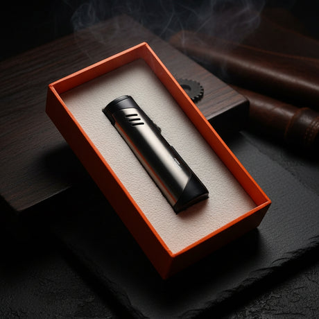 Black lighter in an orange box on a dark surface with smoke in the background