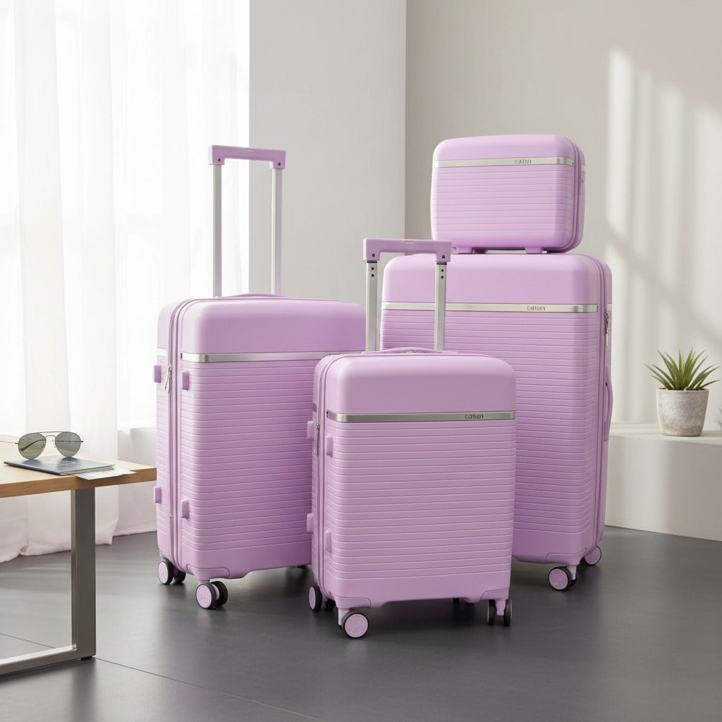 Four purple suitcases with silver trim stacked by a sunlit window