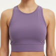 Purple sports bra worn by a person on a white background