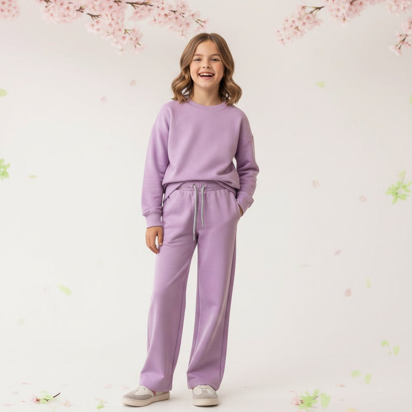 Girl in a lilac sweatshirt and matching wide leg jogging pants