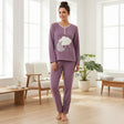 Purple fleece pyjama set with a cloud and grey moon applique and full length bottoms, worn standing