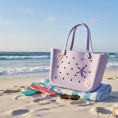 Purple beach bag with floral details on a sandy beach with ocean view