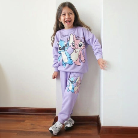 Girl wearing a lilac two piece sweatshirt and jogger set with a blue and pink character print