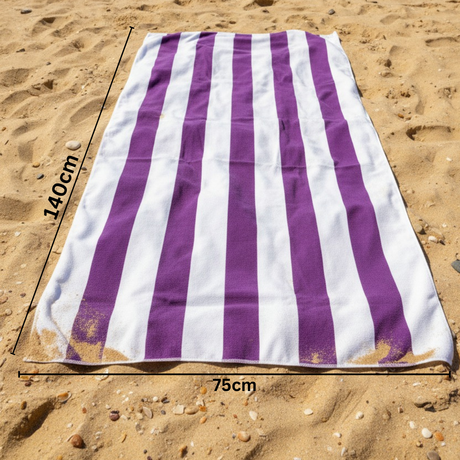 Purple and white striped beach towel on sand with 75x140 cm size measurements
