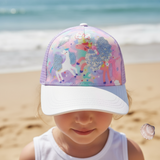 Girl wearing a lilac kids cap with a sequin unicorn, rainbow print and a white glitter brim