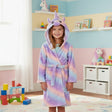 Girl wearing a pastel rainbow unicorn hooded robe with 3D horn