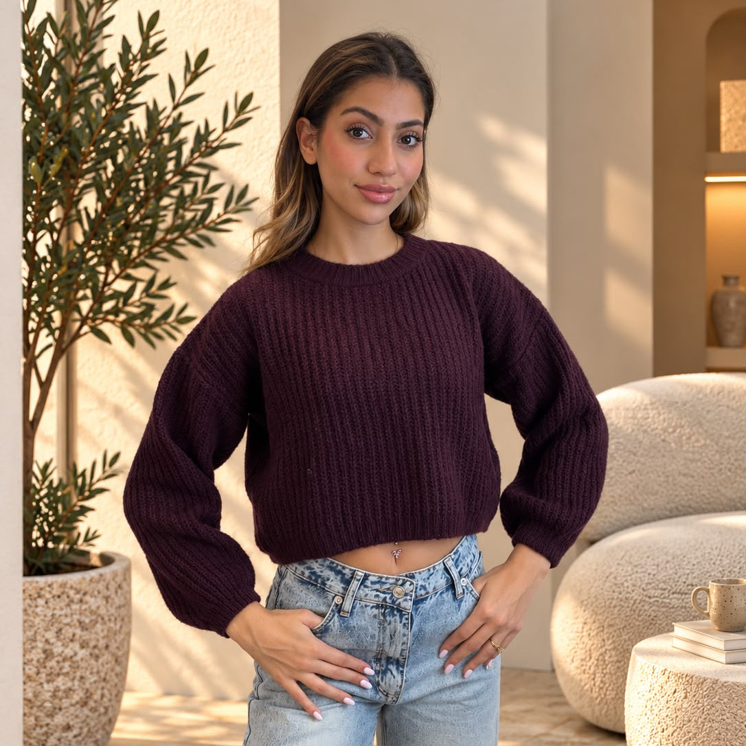 Dark plum ribbed knit cropped sweater with long sleeves, hands on hips