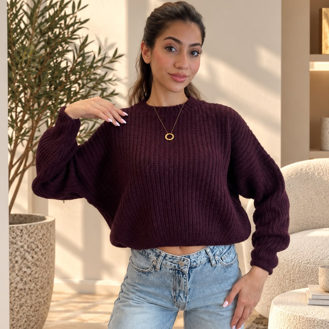 Plum purple chunky rib sweater with a gold pendant necklace and jeans
