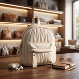 Cream quilted mini backpack with a chevron quilted body