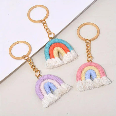 Macrame rainbow keychains in blue, purple and pink on gold rings