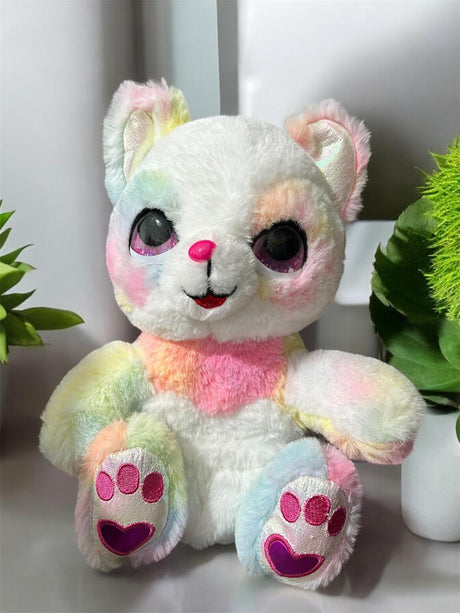 Seated long pile plush in pastel rainbow tie dye with glittery eyes and a heart nose