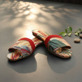 Tapestry slide sandals with a red toe band in a tropical leaf weave