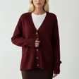 Red cardigan layered open, a white tee showing at the neck