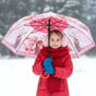 Girl in snow holding an open pink and red Frozen kids umbrella with Elsa and Anna