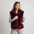 Burgundy hooded faux fur vest over a grey long sleeve top