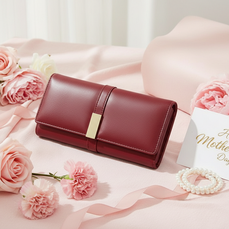 Red leather wallet with pink roses and a 'Happy Mother's Day' card on a pink surface